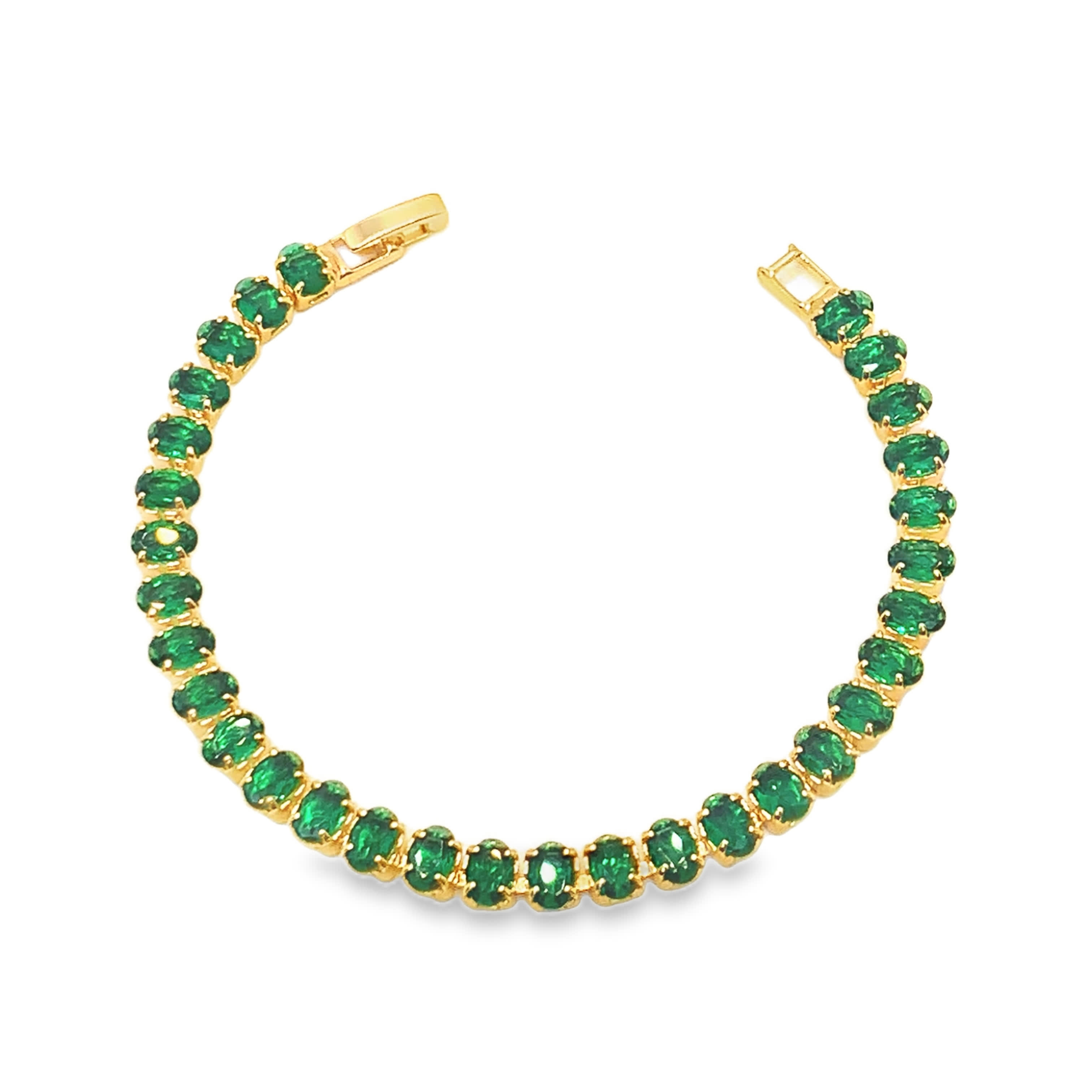 Bransoletka tenisowa w kolorze żółtego złota z owalnymi kaboszonami szmaragdowymi